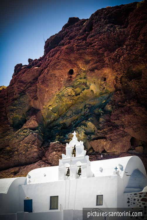 St. Nikolaos Church at Akrotiri, Santorini, standing in front of the island’s dark volcanic cliffs