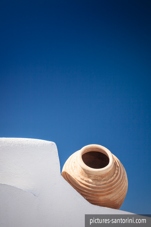 A typical Greek amphora against the deep blue sky